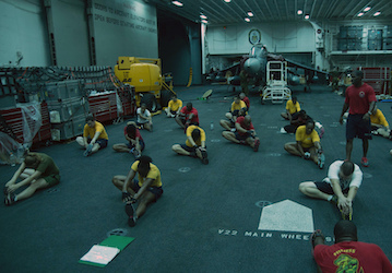 Sailors and Marines stretch in during a military workout  U S  Navy photo by Mass Communication Specialist Seaman Lacordrick 