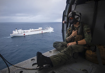 Navy aircrewman in flight looking out over water demonstrates resilience to post-traumatic stress   U S  Navy photo by Mass C