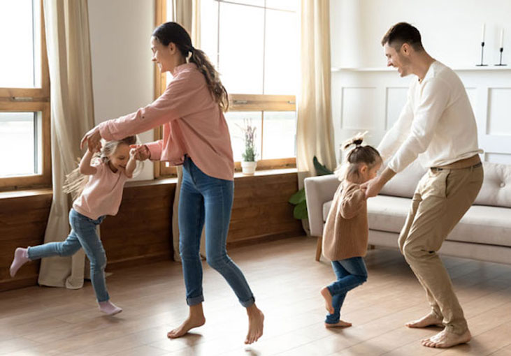 Family dancing and having fun together to relax and bond