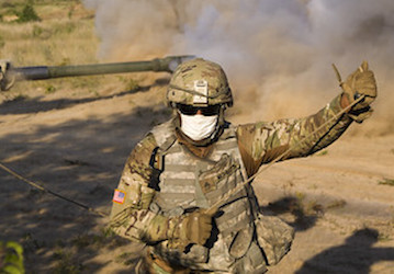 Military soldier wears a face mask and completes a military fitness exercise with resilience