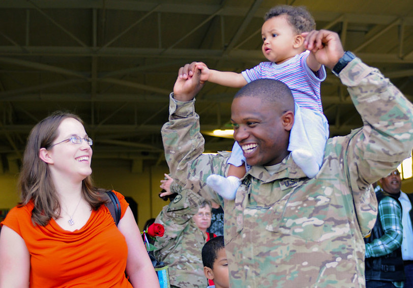 Soldier in uniform is happy with in his family relationship and experiences military wellness