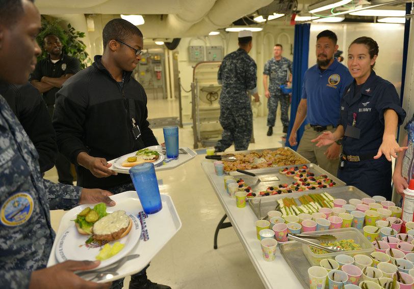 Hospital Corpsman 2nd Class Stephanie Conn discusses healthy snack choices with Sailors   U S  Navy photo by Mass Communicati