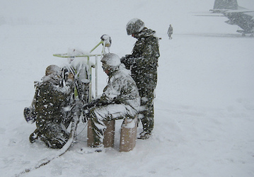Airmen and Marines working on a snowy airfield rely on good communication and teamwork to prevent injury   US Air Force photo