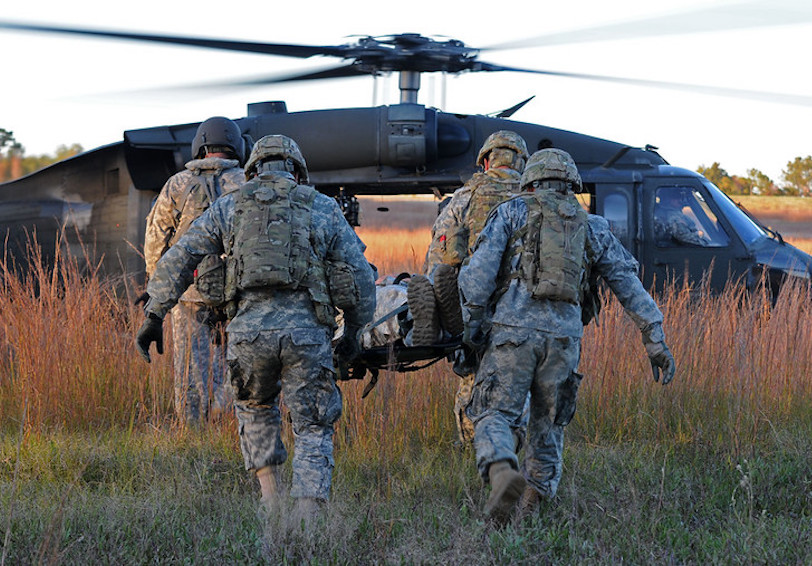 Service Members practice a medical evacuation during military training and need teamwork and good communication to optimize p