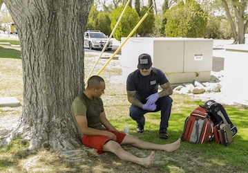 EMS treats injured Marine with signs of heat injury during military workout  Photo by Jack Adamyk 