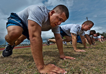 Airmen doing mountain climber exercises on the field improve physical fitness for optimal military performance    US Air Forc