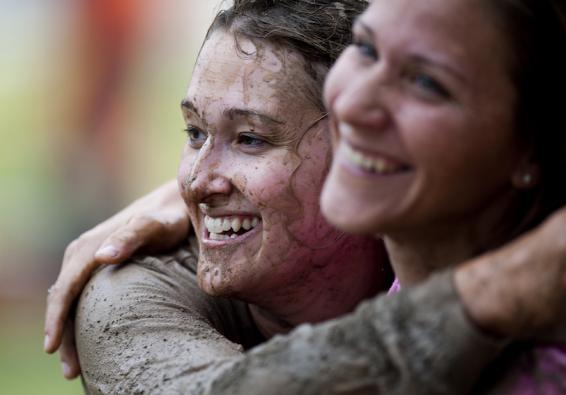 Women hug after completing Women s History Month Ultimate Dirty Dash celebrate resilience and teamwork     U S  Air Force pho