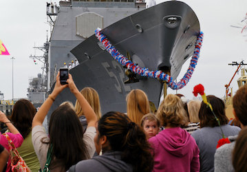 Family and friends at a Naval station show resiliency as they welcome sailors on a ship returning from deployment   U S  Navy