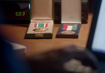 Still from the video showing medals earned through military service