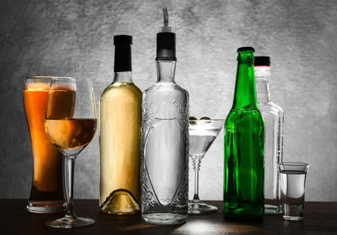 Bottles and glasses of alcoholic drinks which can affect military performance  health  and total force fitness