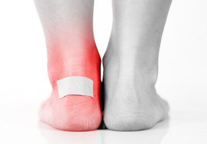Black and white image of heels with one bandaged and shaded red showing the importance of injury prevention 