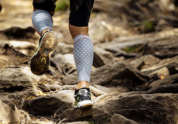 Runner wearing compression sleeves to reduce soreness for optimal performance 