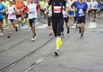 marathon runners during street race follow HPRC training tips for optimal performance  