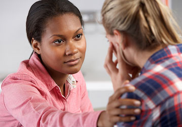 Woman being comforted by another woman showing the importance of reaching out for help with mental health 