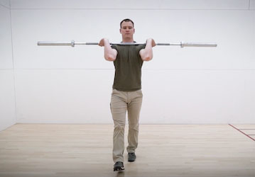 Man performing front-rack carry to improve military fitness 