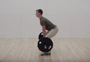 Man performing a deadlift with correct form during a workout to optimize military fitness and prevent injury 