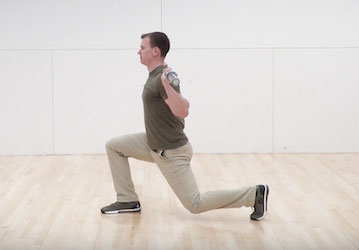 Man performing back-rack lunge to improve military fitness and prevent injury 