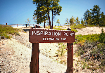 Wooden sign with words  Inspiration Point  Elevation 8100  on path near wooded area highlighting options for family optimizat