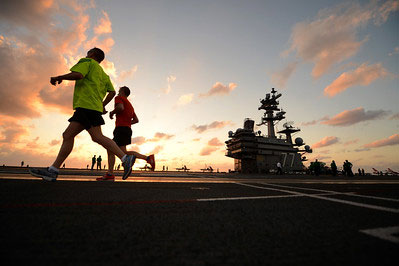 Service Member running on flight deck run to improve military fitness  U S  Navy photo by Mass Communication Specialist 2nd C