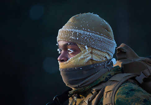 Military service member in uniform braving the weather with strategies for training, fitness, and injury prevention during cold weather. (U.S. Marine Corps photo by Lance Cpl. Cody Rowe)
