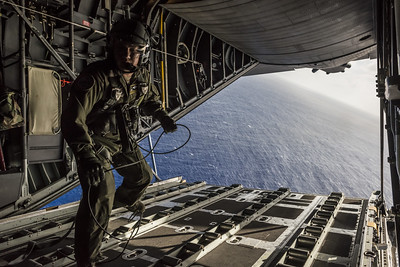 Airman walks from the ramp of a C-130 Hercules aircraft   DoD photo by Tech  Sgt  Samuel Morse  U S  Air Force Released 