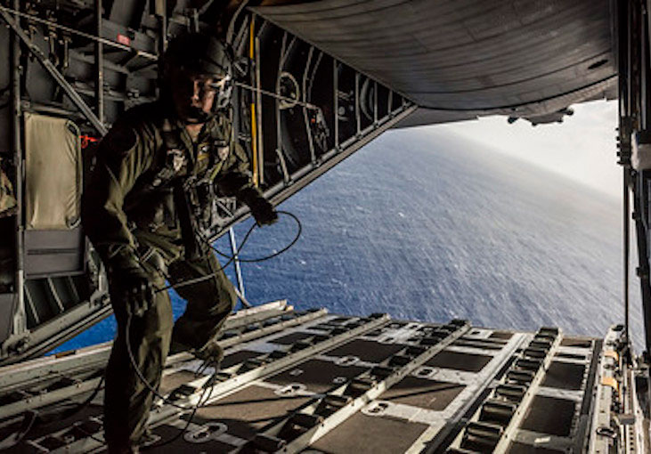 Airman walks from the ramp of a C-130 Hercules aircraft   DoD photo by Tech  Sgt  Samuel Morse  U S  Air Force Released 