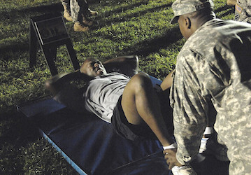 Soldier completing sit-ups to optimize military performance and total force fitness with core-strength training  Photo by Mik