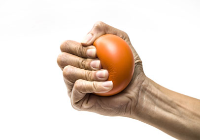 Person practicing stress management and mental health by squeezing a stress ball