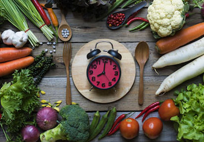 Pink clock centered around vegetables that fuel performance nutrition  military workouts  and training 