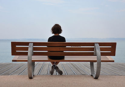 Lonely person on bench in need of HPRC relationship building strategies for improved mental well-being  