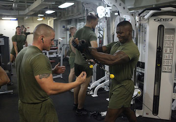 Marine lifts weight during military workout using injury prevention strategies from HPRC   Official USMC photo by Sgt  Jesse 