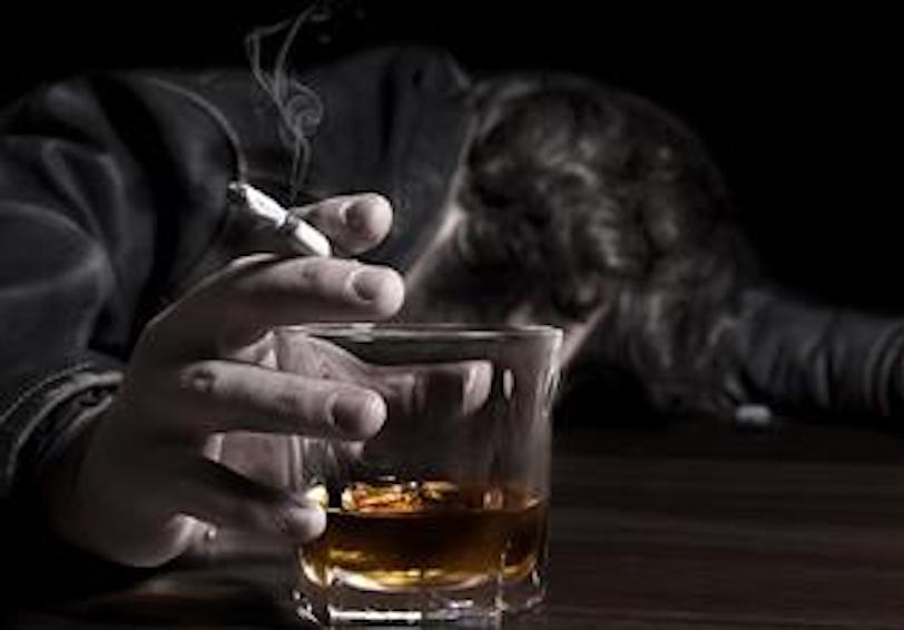 Person holding cigarette and glass of liquor needs Navy substance abuse resources for recovery and wellness 