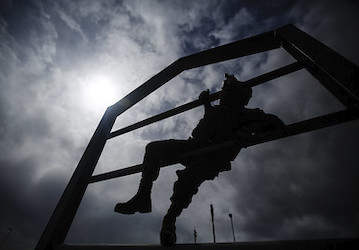 Uniformed Marine climbs military workout obstacle through Total Force Fitness and resilience   U S  Marine Corps photo by Lan