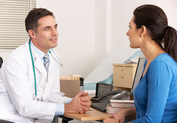Woman talking to her doctor regarding strategies to improve sleep for optimal mental and physical health  