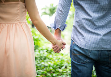 Couple holding hands to build intimacy and optimize their relationship 