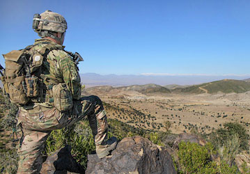 Soldier looking out over mountain valley exhibiting his military fitness and holistic health   U S  Army photo by Sgt  1st Cl