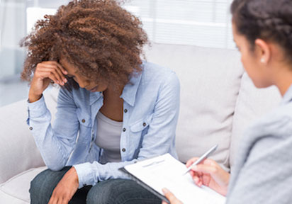 Woman talking to a counselor to improve mental health and prevent suicide 