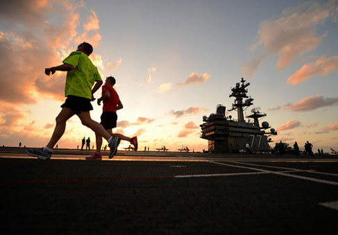 Sailors running on ships deck to improve military fitness and optimize performance   U S  Navy photo by Mass Communication Sp