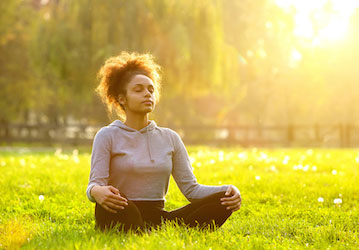 Woman meditating and practicing holistic performance optimization skills for military wellness 