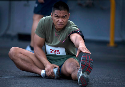 Military Service Member stretching to prevent injury and optimize performance    U S  Marine Corps photo by Sgt  Elyssa Quesa