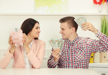 Smiling couple in relationship holds piggy bank and saves money through teamwork and communication 
