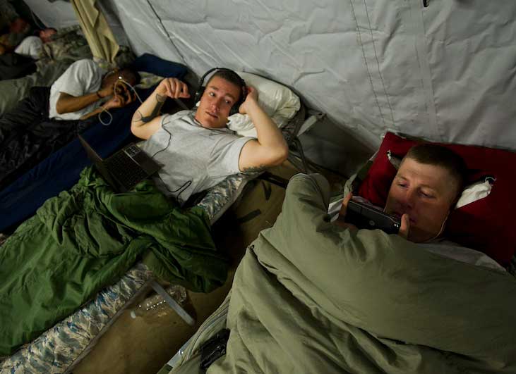 Airmen watch movies before falling asleep in Kalsu, Iraq. Photo by Master Sgt. Jeffrey Allen