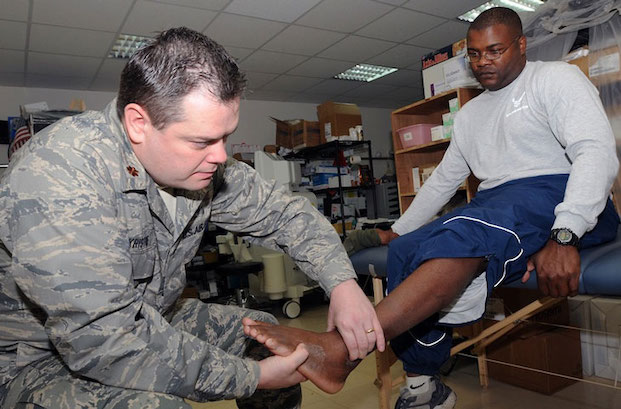 Doctor examines soldier s sprained ankle to help with recovery and military wellness  Photo by Staff Sgt  Joshua Breckon