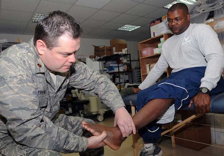 Doctor examines soldier s sprained ankle  Photo by Staff Sgt  Joshua Breckon