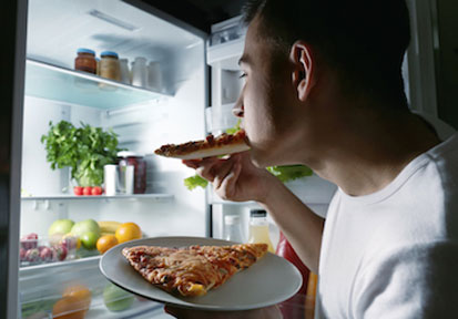 Man searching fridge for late night snack needs HPRC resources on performance optimization and performance nutrition to fuel 