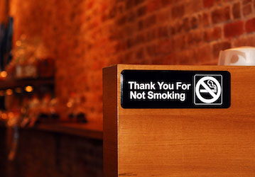 Thank you for not smoking sign hangs in restaurant to preserve military fitness of Service Members with smoking cessation resources