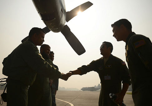 Group of airmen talking and shaking hands on air strip showing good communication skills and relationship building   U S  Air