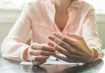 Woman removes her wedding ring and thinks about ending her relationship with her military spouse