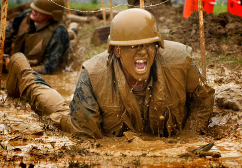 Sailor crawling through mud obstacle  U S  Navy photo by Midshipman 3rd Class Dominic Montez Released 