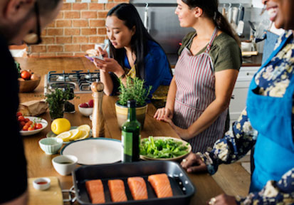 Group of people cooking together learn essential kitchen skills for healthy eating and holistic wellness  